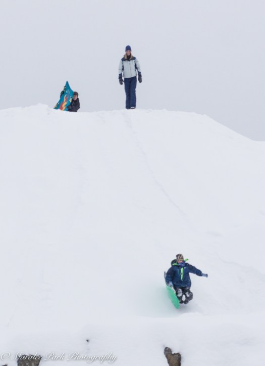 Take a massive mound of dirt and 3 feet of snow and you've got a place to slide.